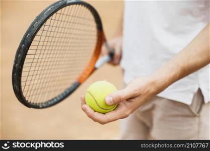 man holding tennis ball racket