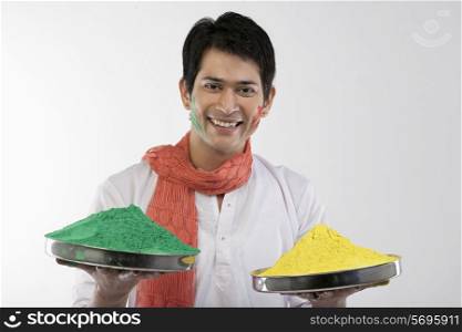 Man holding trays with colours