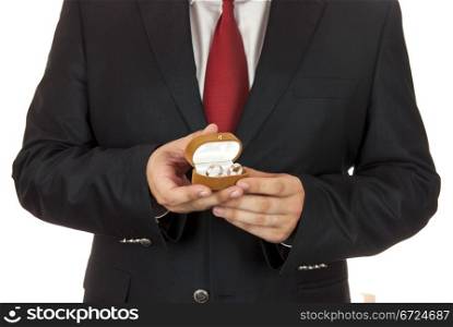 Man holding two wedding rings in his hands
