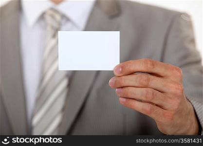 Man holding up a blank business card
