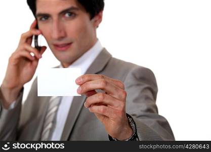 Man holding up his business card