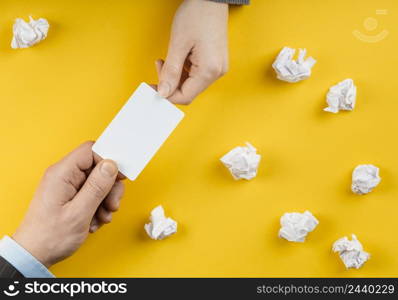 man holding white empty card