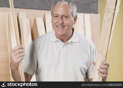 Man holding wooden planks