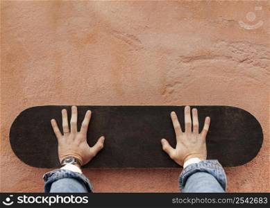 man holding wooden skateboard 3