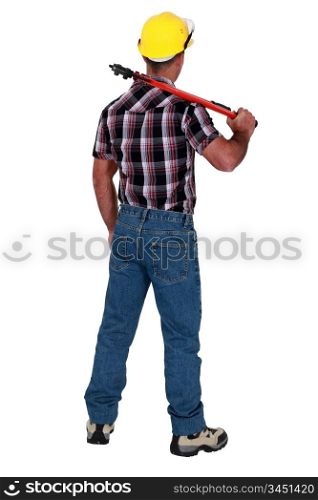 Man holding wrench with back turned
