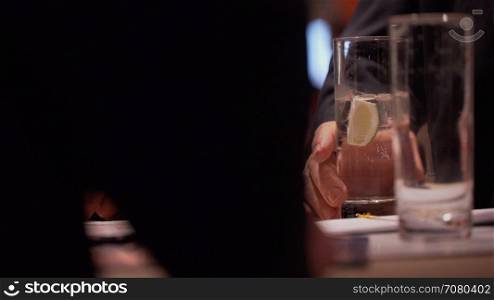 Man holds drink at a conference