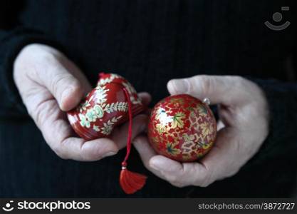 Man holds old holiday ornaments.