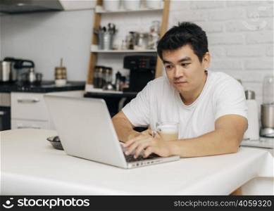 man home during pandemic using laptop
