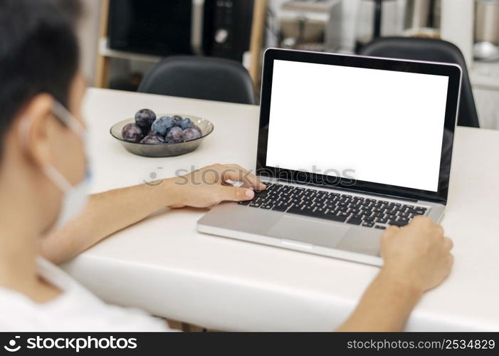 man home with medical mask during pandemic laptop