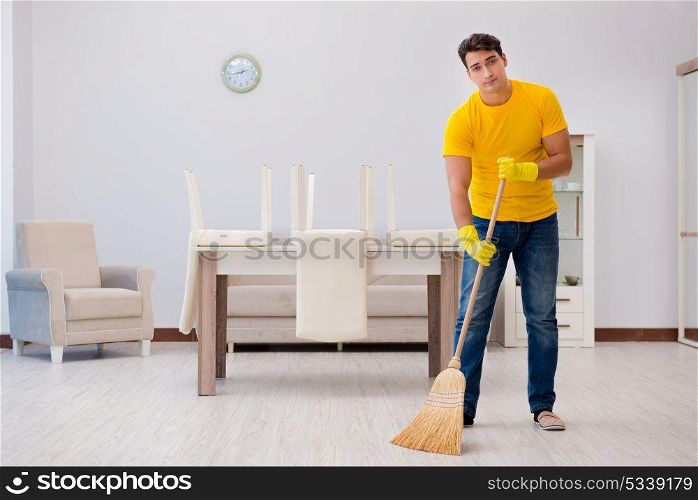 Man husband cleaning the house helping his wife
