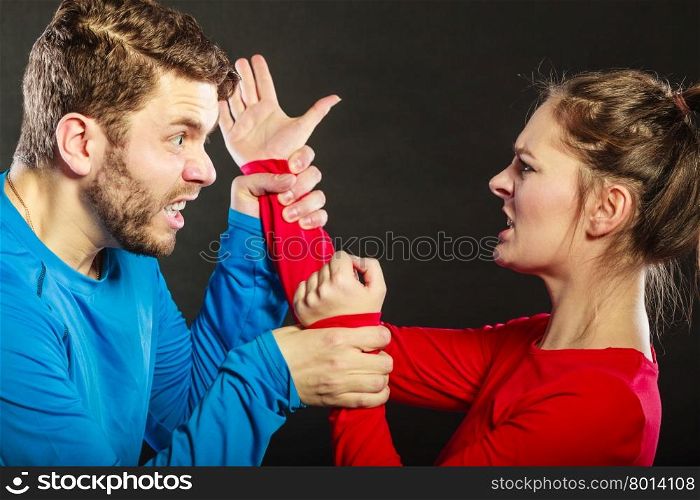 Man husband fighting with woman wife. Violence.. Husband fighting with wife. Aggresive man and woman in studio on black. Domestic violence aggression. Bad relationship.