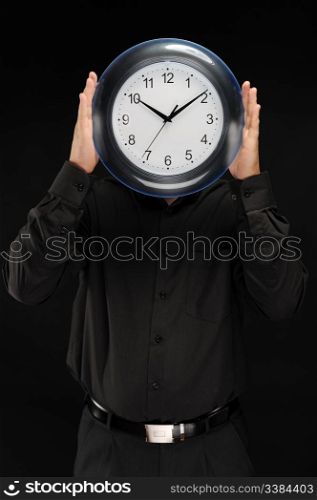 man in a black shirt holds hours in the face of