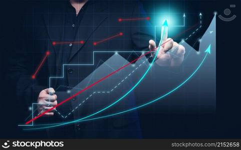 man in a black shirt stands in front of a holographic graph with growing indicators. Business growth, sales increase. High performance