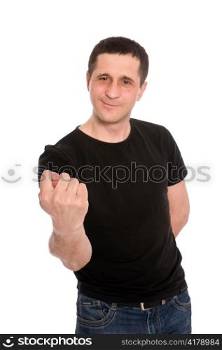 man in a black T-shirt showing a fig isolated on white background
