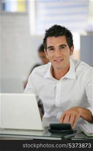 Man in a crisp white shirt using a laptop