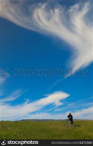 Man In A Field With A Tripod