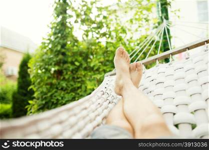 Man in a hammock on a summer day, close up photo