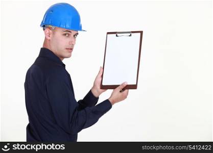 Man in a hardhat with a blank clipboard