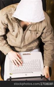 man in a hood with a laptop