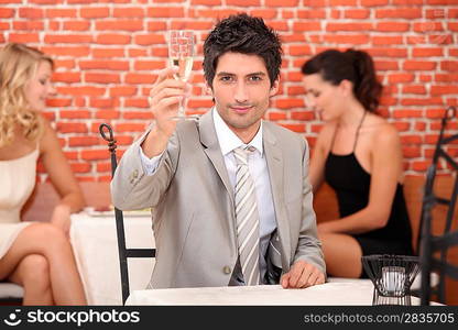 Man in a restaurant with a glass of champagne