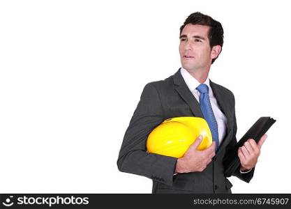 Man in a suit and helmet with folder