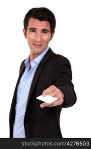 man in a suit giving his business card