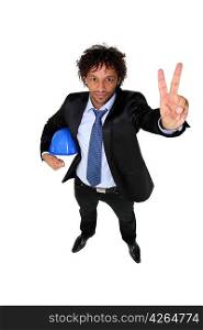 Man in a suit holding a hardhat and giving the peace sign