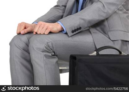 man in a suit sitting and waiting