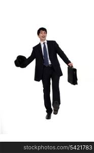 Man in a suit with briefcase and hat