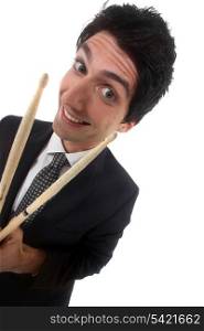 Man in a suit with drum sticks