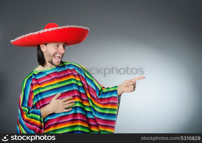 Man in a vivid mexican poncho gray background isolated