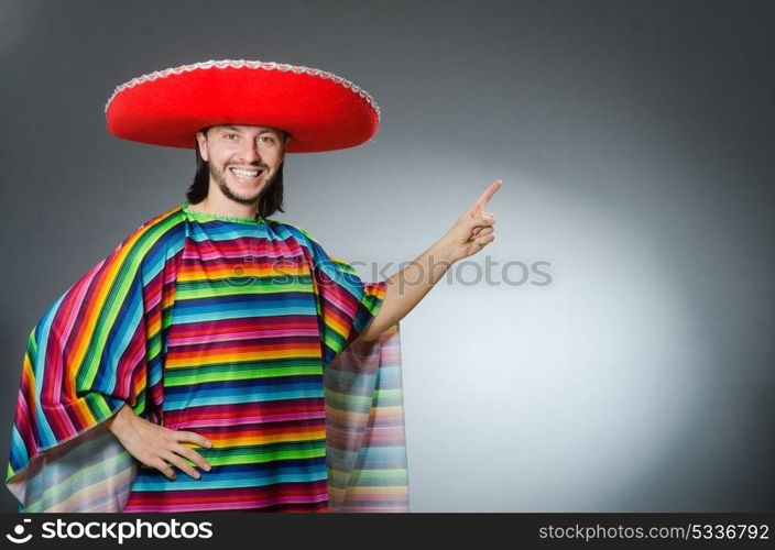 Man in a vivid mexican poncho gray background isolated