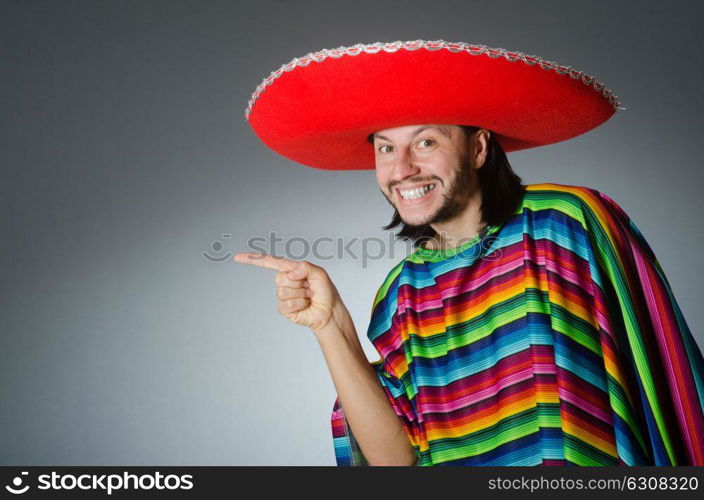 Man in a vivid mexican poncho gray background isolated