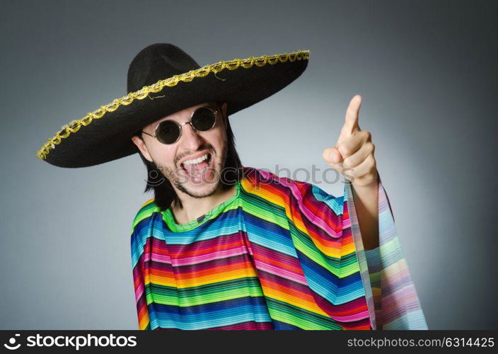 Man in a vivid mexican poncho gray background isolated