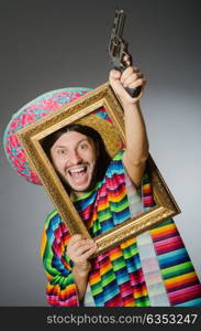 Man in a vivid mexican poncho gray background isolated