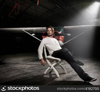 Man in a warehouse with an airplane.