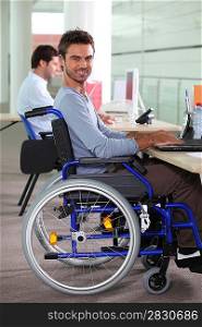 Man in a wheelchair using a computer