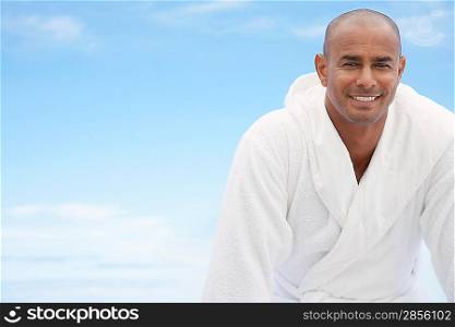 Man in bathrobe smiling half length