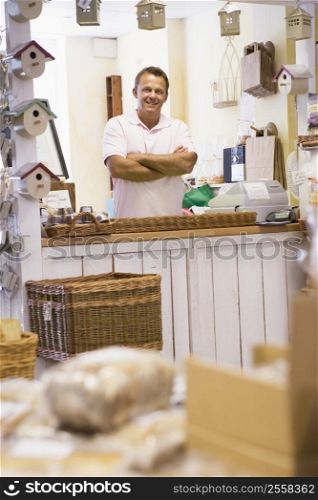 Man in birdhouse store smiling