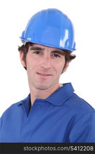 Man in blue overalls and hardhat