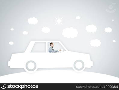 Man in car. Young man driving car made of sheet of paper