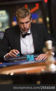Man in casino playing roulette (selective focus)