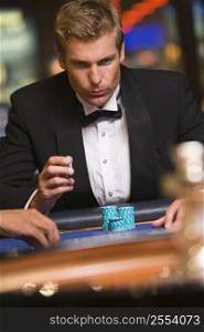 Man in casino playing roulette (selective focus)