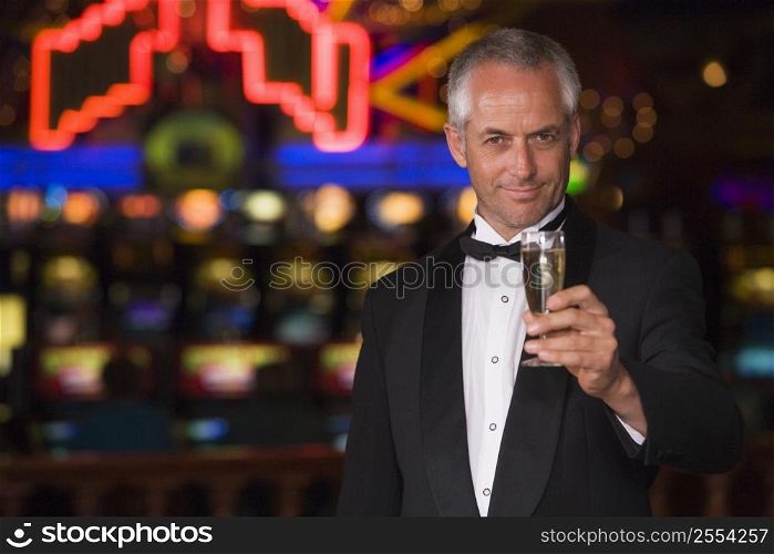Man in casino with champagne smiling (selective focus)