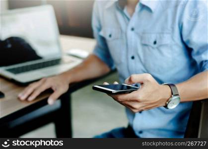 man in casual form using mobile phone at modern office.