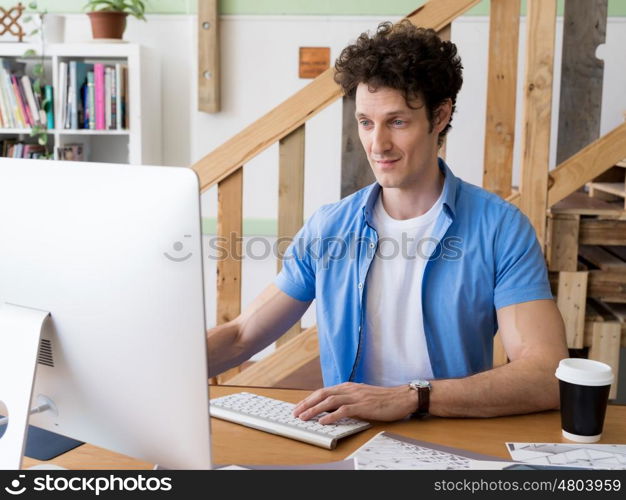 Man in casual wear working in office