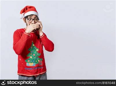 Man in christmas hat talking on the phone secretly. Christmas guy talking on the phone secretly, Christmas person talking on the phone secretly covering his mouth