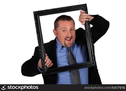 man in coat and tie holding frame