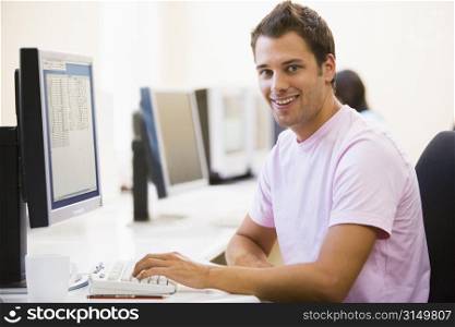 Man in computer room smiling