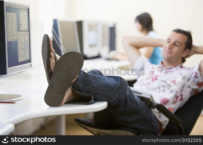 Man in computer room with feet up relaxing